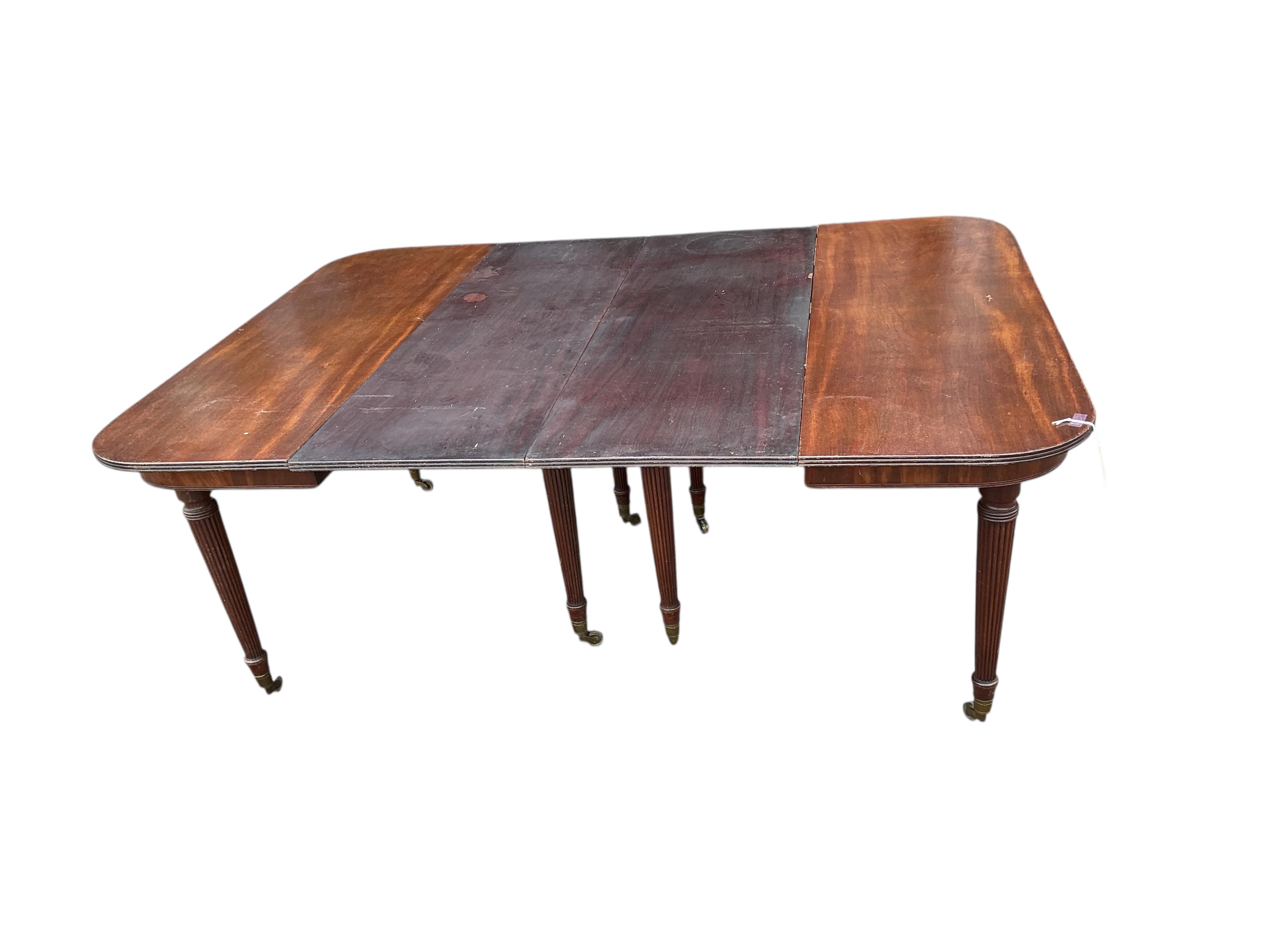 A Regency mahogany extending dining table, width 180cm extended, two spare leaves, depth 140cm, height 74cm
